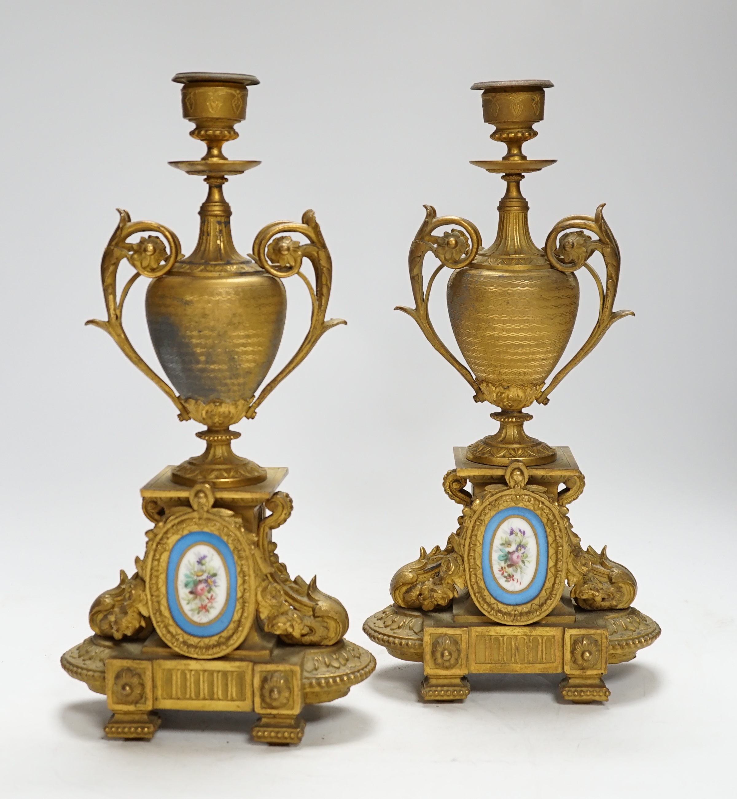 A pair of 19th century French ornamental gilt metal candlesticks, possibly clock garnitures, 32.5cm high